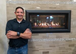 Man standing in front of fireplace in wall